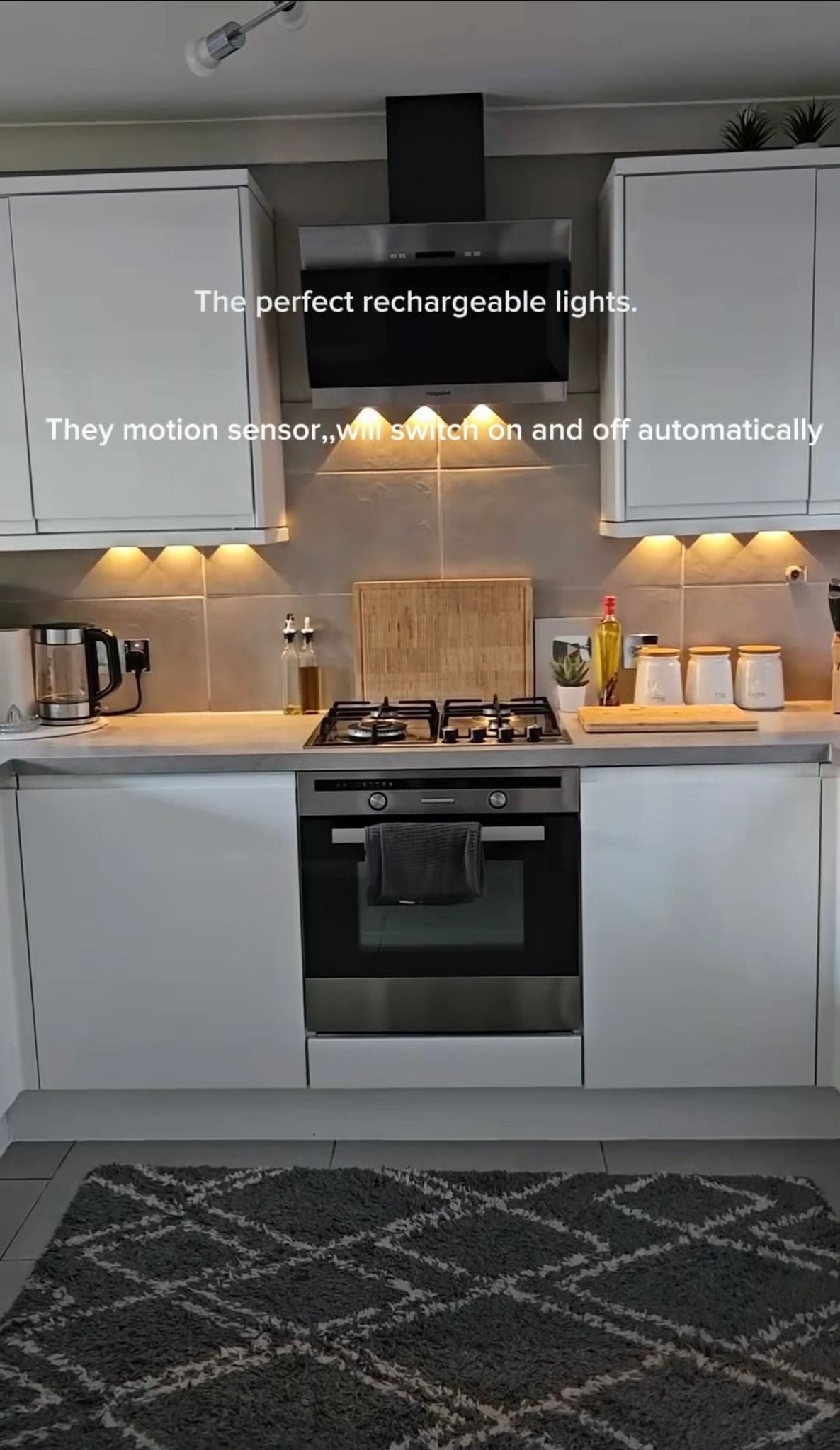 Modern kitchen with motion sensor lights on a gray rug